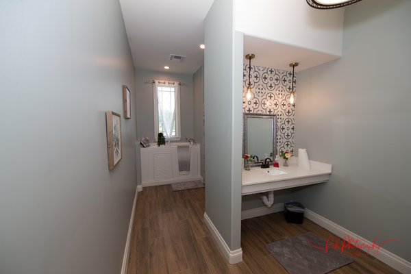 Looking into one of 4 shower rooms, equipped with both walk in tubs and private showers