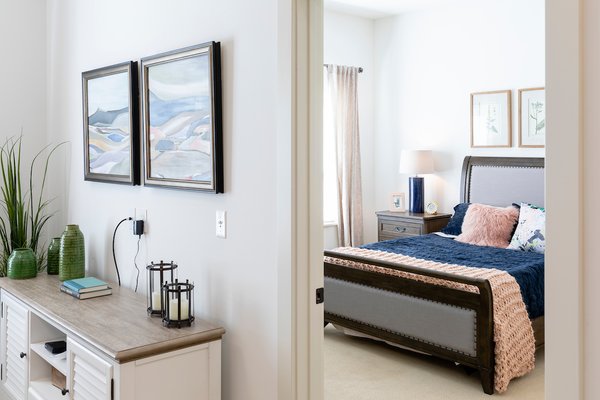 A peek into the bedroom of an assisted living apartment from the living area.