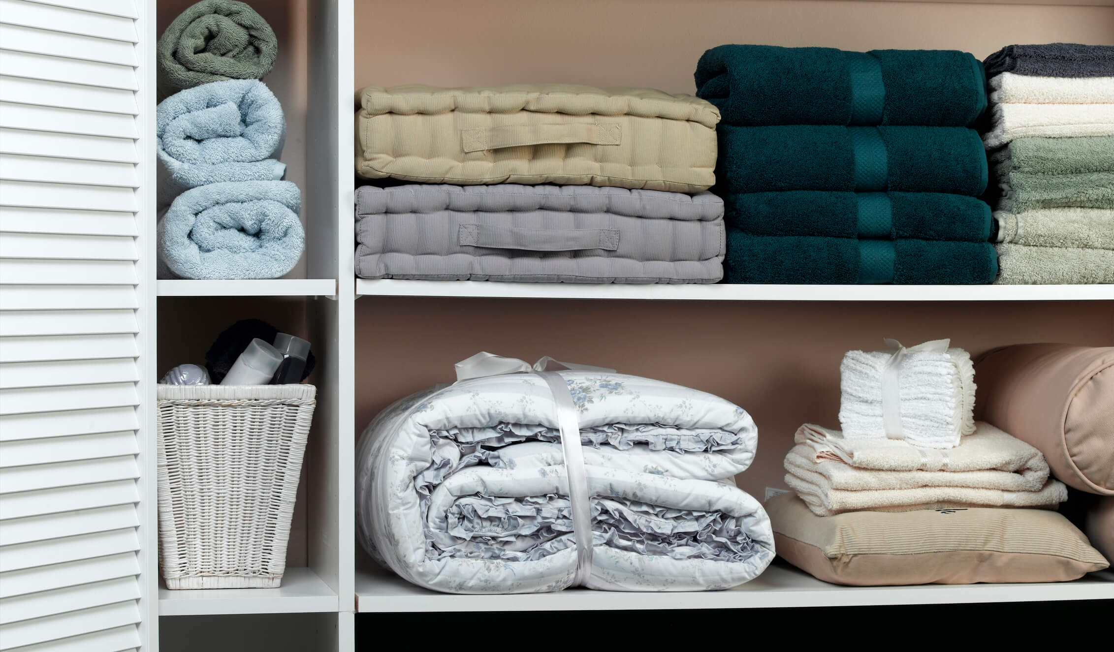 The inside of a linen closet with folded sheets and towels