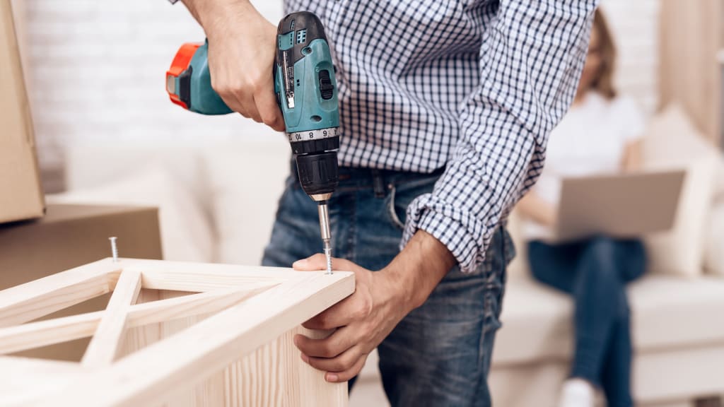 A man doing carpentry work as part of handyman services list