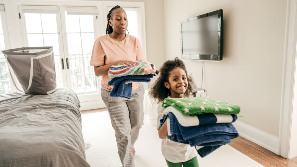 a young girl doing age appropriate chores for kids to do