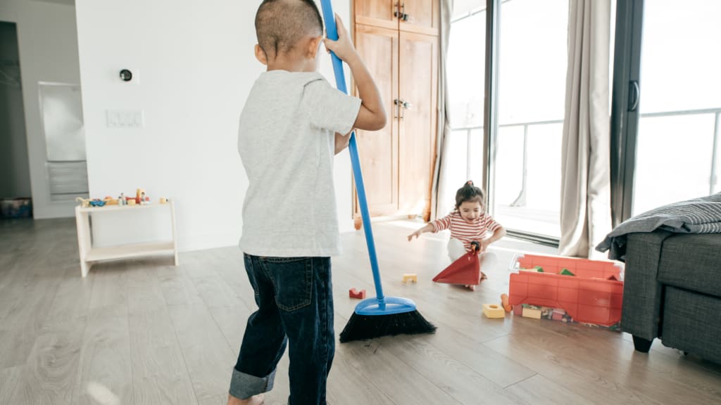 two toddlers work on age appropriate chores for kids to do