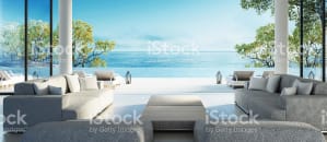 Patio furniture sits in front of the ocean