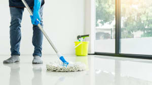 person mops, wondering is it safe to hire a cleaning service during covid-19