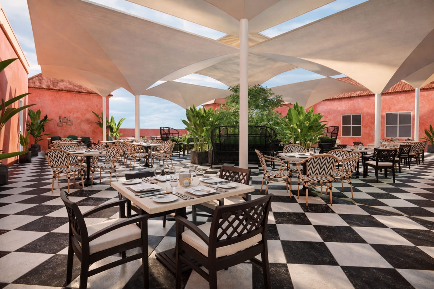 Rendu d'une terrasse ombragée au sol en damier dans une cour historique du resort The Pyrmont Curaçao