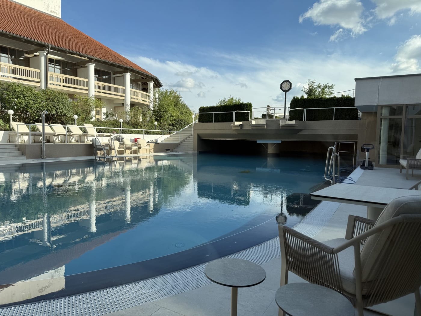 La piscine thermale extérieure de l'Ensana Fürstenhof et ses fauteuils au bord de l'eau