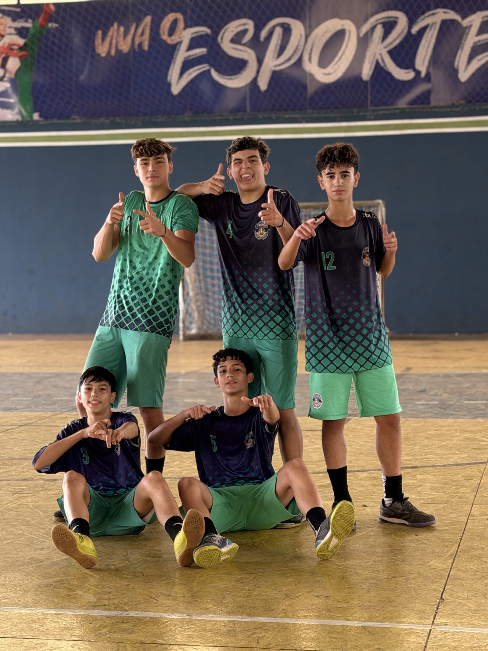 Cinco alunos da Da Vinci Academy reunidos na quadra poliesportiva durante atividade esportiva
