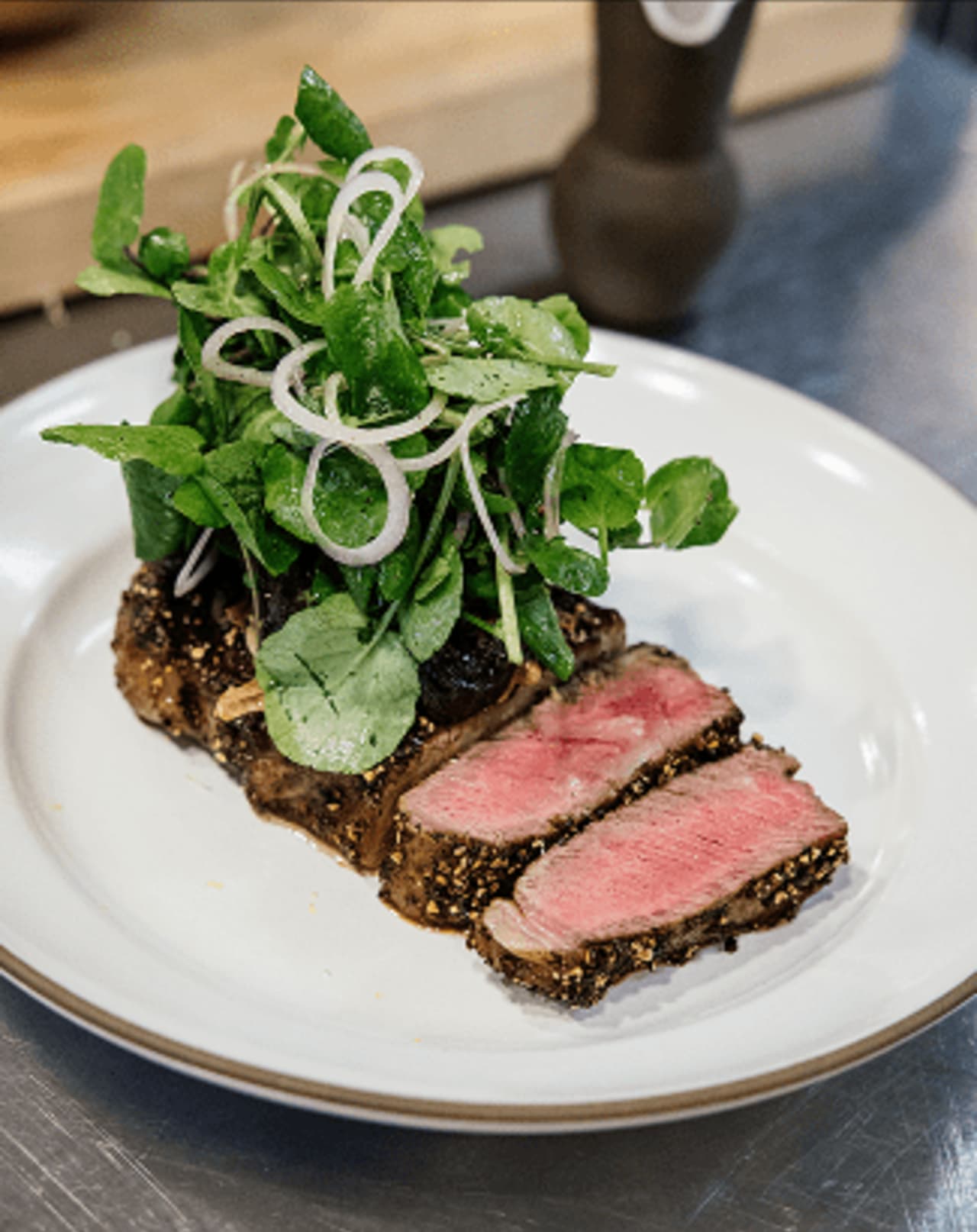 Chef Chris Cosentino's Wagyu Striploin au Poivre with Snails, Garlic, Parsley & Watercress. St. Helena, CA