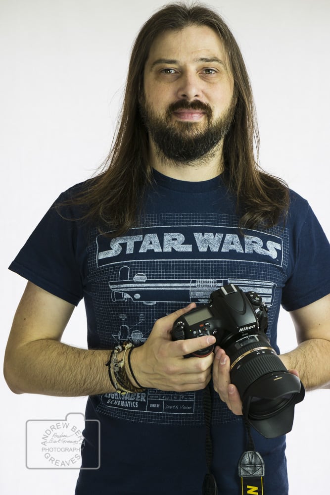 Photographer Andrew Bert Greaves holding a camera