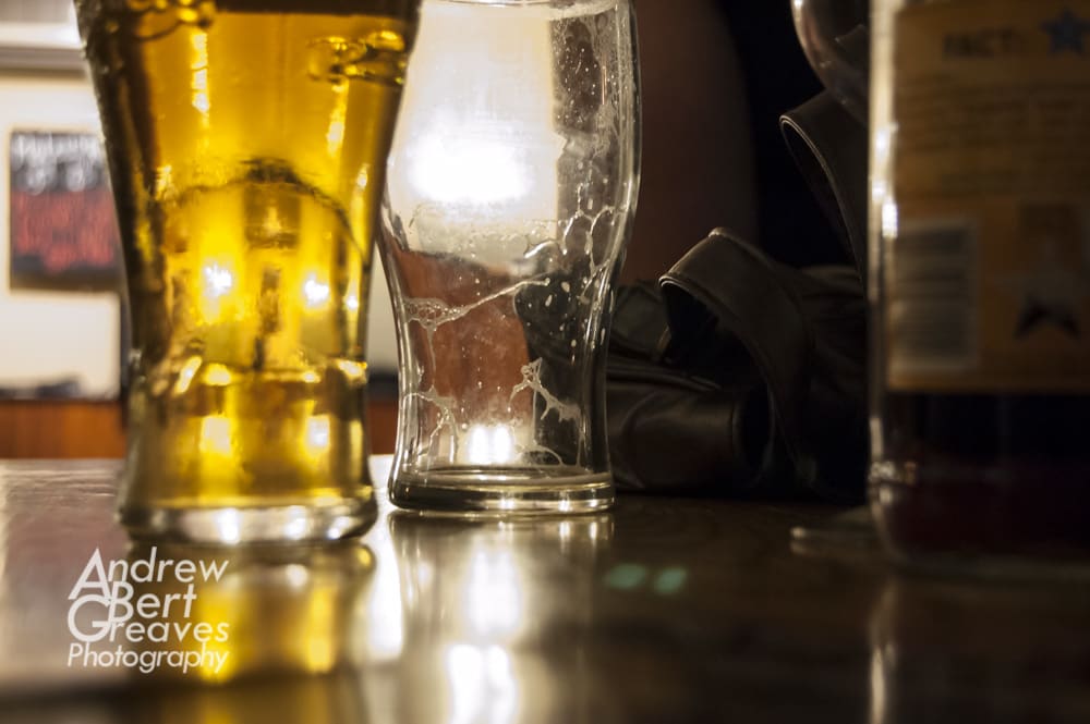 an empty pint glass and a full pint glass