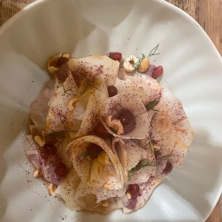 photo of Nugolo Carpaccio Di Sedano Rapa, Nocciole, Melograno E Crema Di Cipolla Rossa shared by @margheritacacini86 on  21 Apr 2023 - review