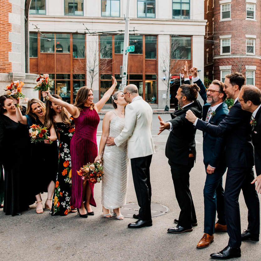 Andrew and all the groomsmen standing in a straight line in an alley behind Alden & Harlow