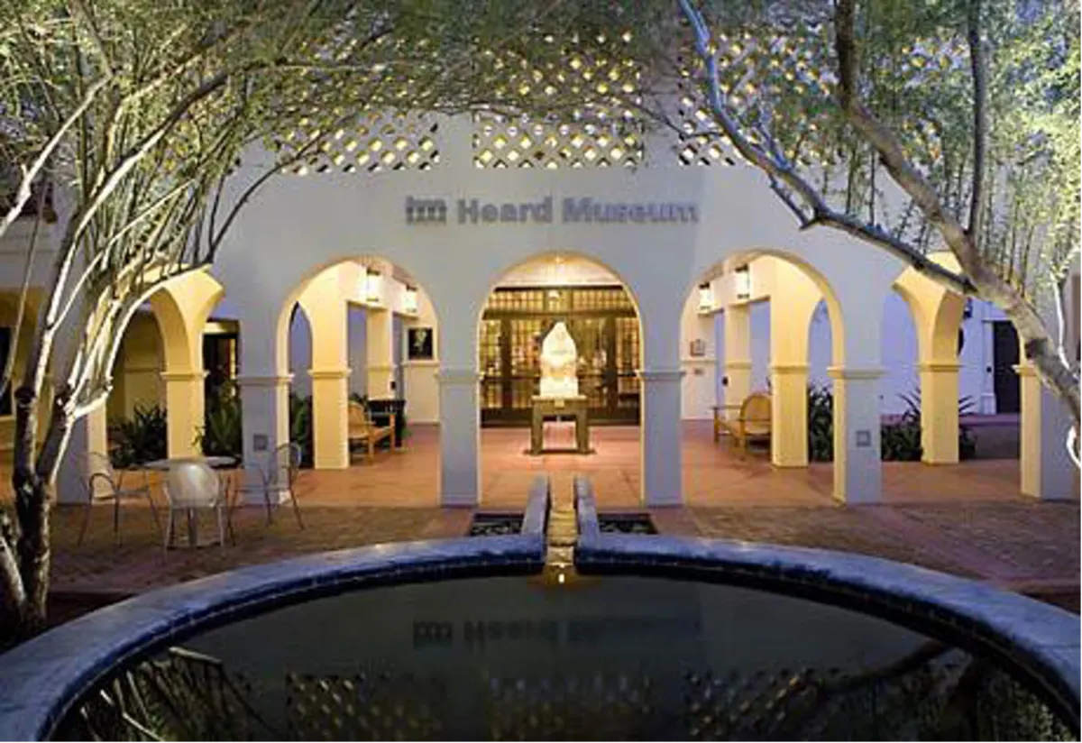 outdoor patio of the heard museum, circular fountain glistening in evening glow