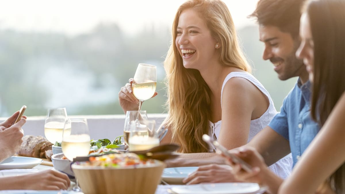 Friends enjoying wine tasting at a dinner party