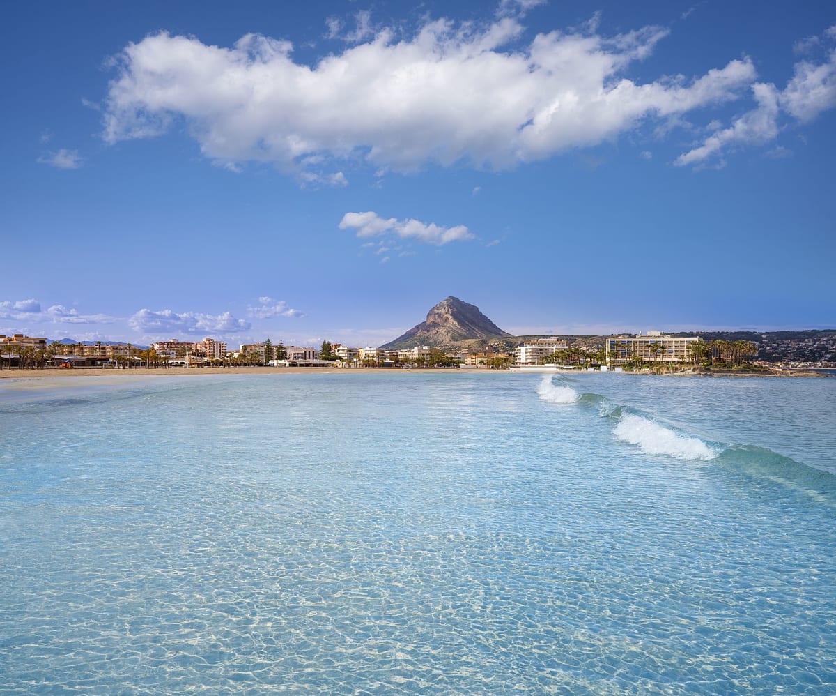 Playa El Arenal beach in Jávea with palm trees and Mediterranean waters
