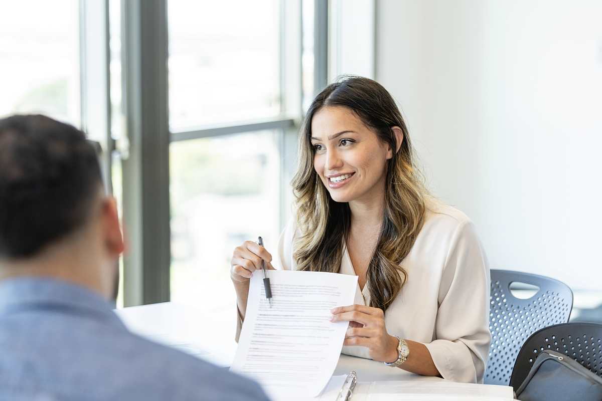 Lånerådgiver som gjennomgår boliglånsdokumenter for eiendomskjøp i Spania