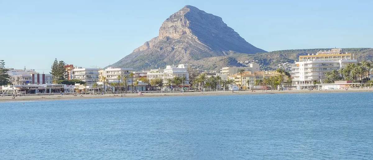 Montgo mountain rising behind a sandy beach near Javea