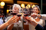 Group of friends toasting at a wine tasting on the coast