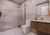 Modern bathroom with marble-effect tiles and walk-in shower
