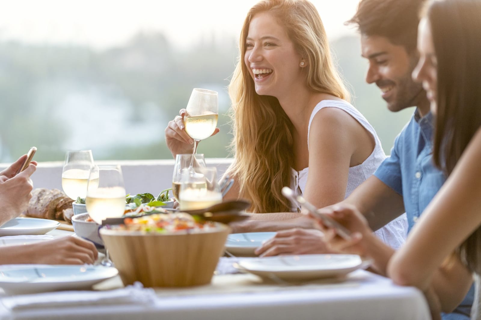 Friends enjoying dinner together at sunset in Spain