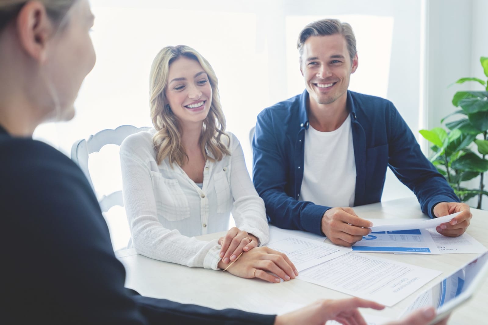Estate agent discussing property documents with couple