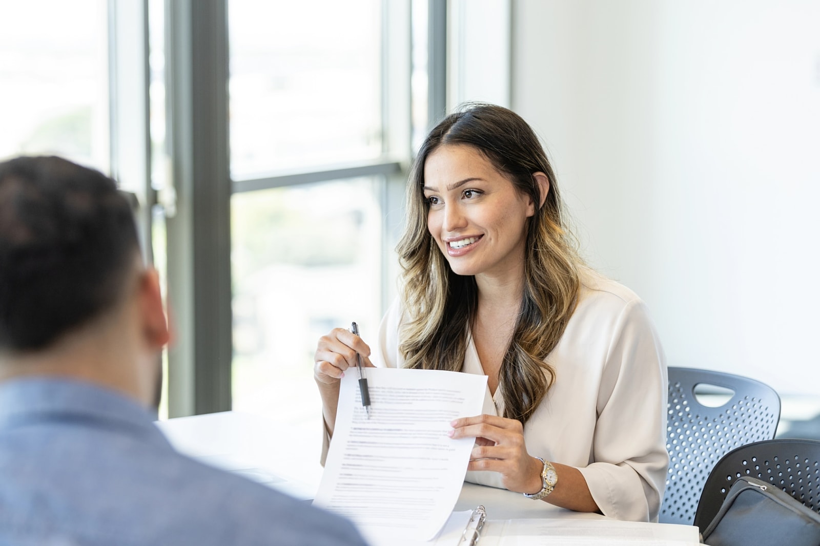 Confident loan officer reviewing mortgage documents with clients