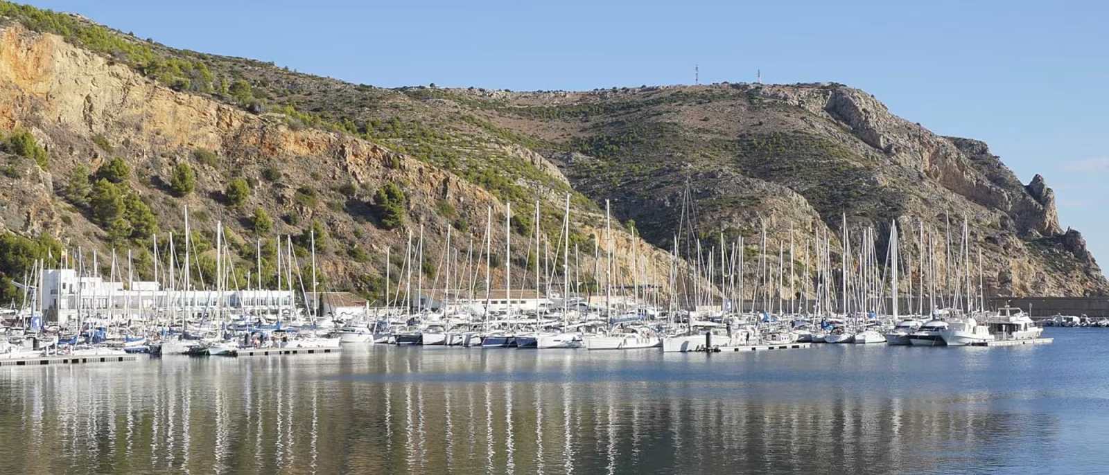 Javea marina with boats and waterfront apartments