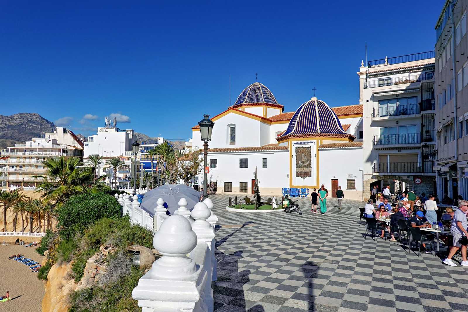 People enjoying a sunny day in Benidorm old town, Plaza de Santa Ana, Alicante province, Spain