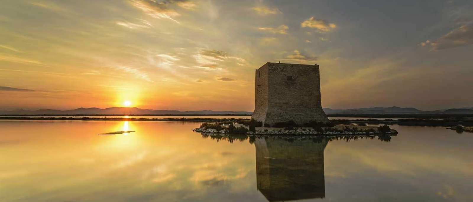 Sunset over Santa Pola harbour and the Mediterranean coastline