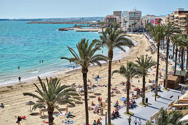 Tourists sunbathing at Playa del Cura