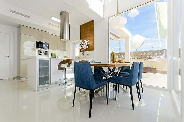 Open-plan kitchen and dining area opening to the terrace