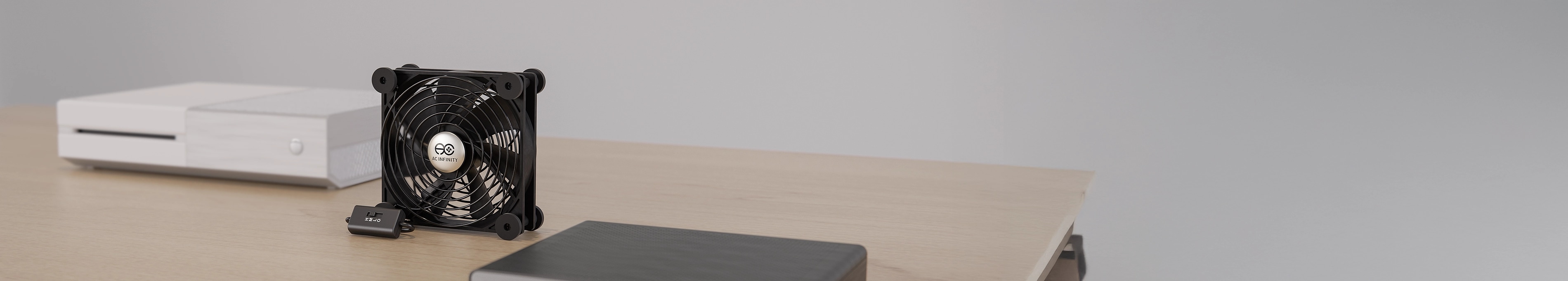 Multifan series USB cooling fan standing on a wooden desk next to a white gaming console.