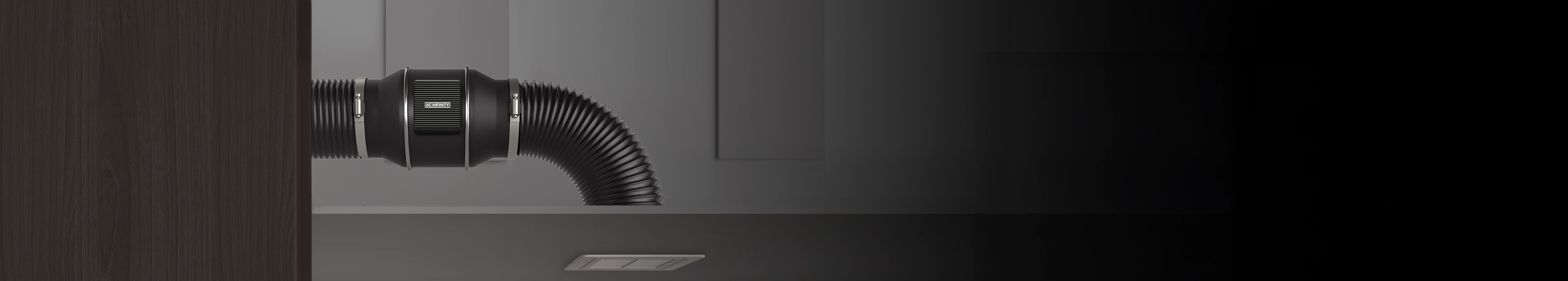 Cloudline series inline duct fan connected to flexible black ducting in a residential attic space.