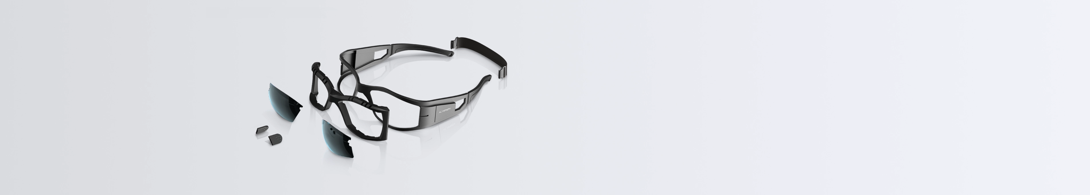 Disassembled black grow room glasses showing the main frame, a detachable inner frame, two tinted lenses, and nose pad pieces against a light background
