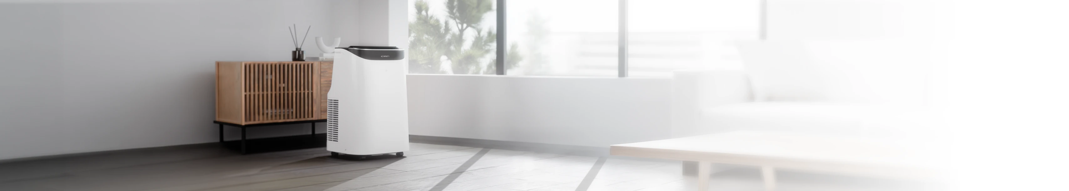 White portable air conditioner in a modern, bright living room setting.