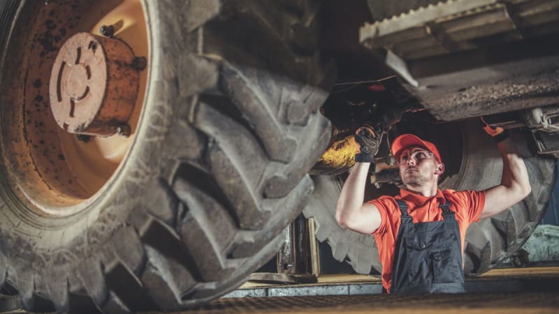 Male mechanic working on a large vehicle