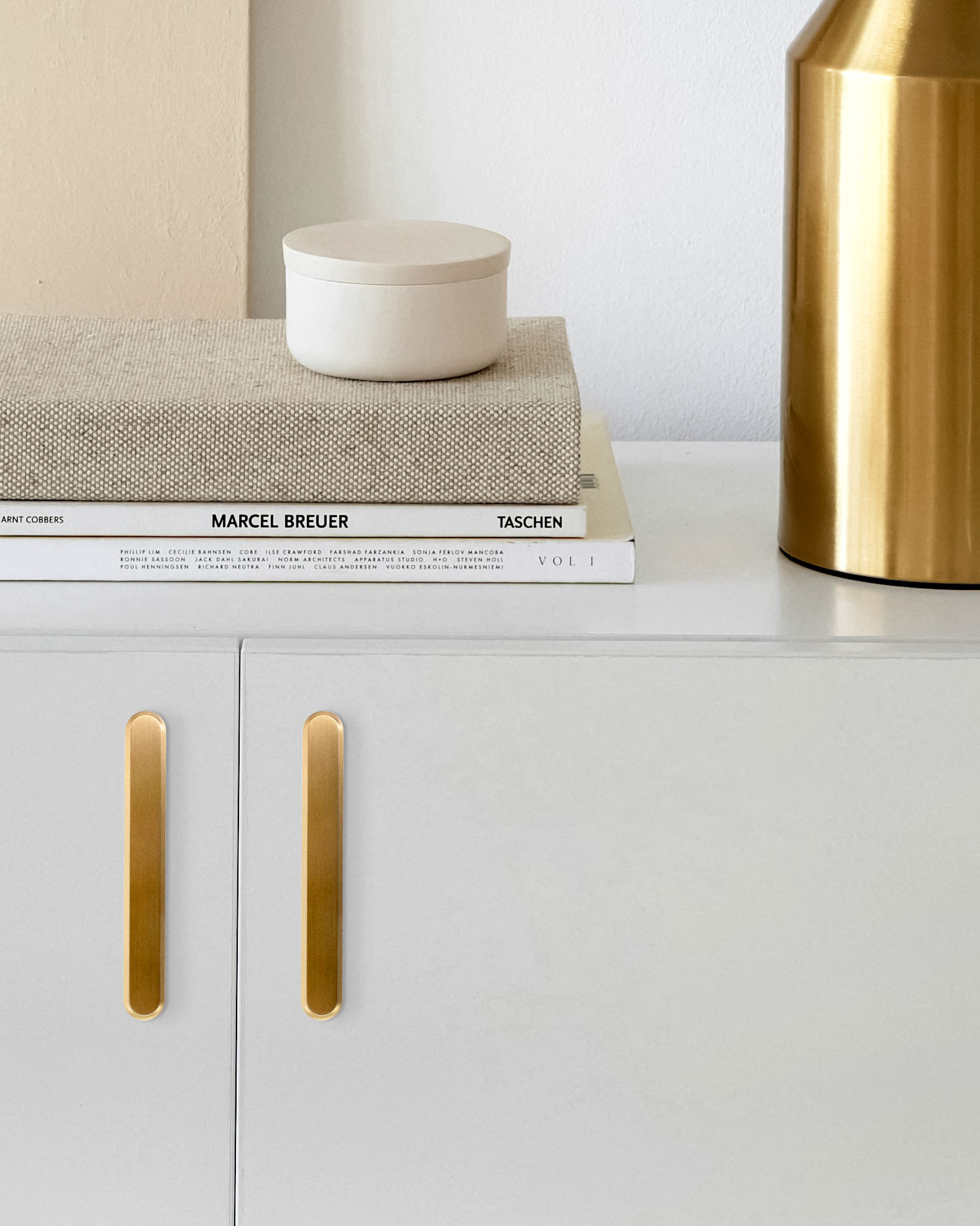Thom Filicia for Accurate Cabinet Hardware Henderson Pulls in BB mounted on white cabinet