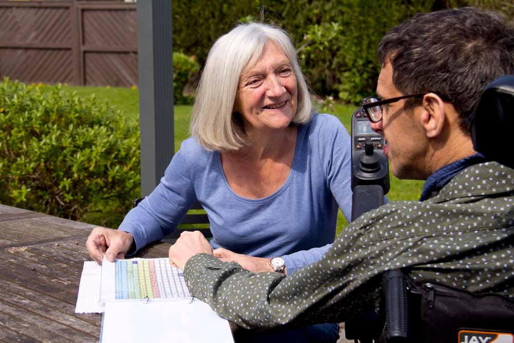 Two people outside looking happy