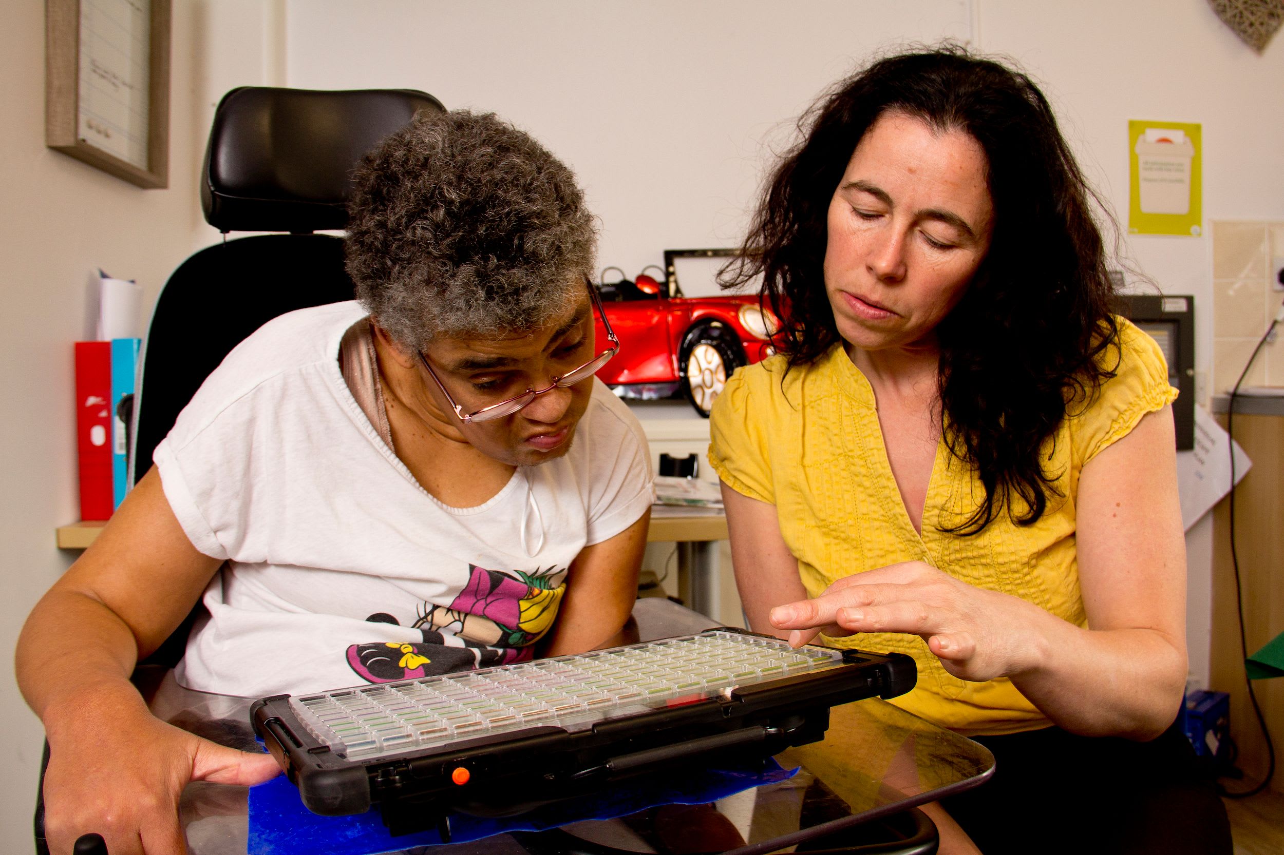 Two people looking at a communication device