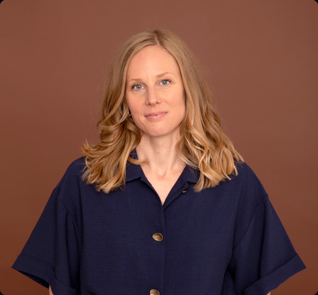 Caitlin Cockerton, wearing a blue blouse, facing the camera.