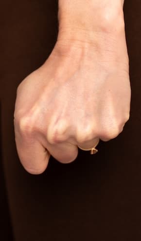 A hand curled into a tight fist