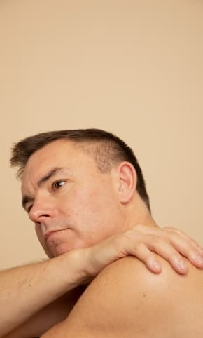 Person looking off camera, with hand draped over shoulder