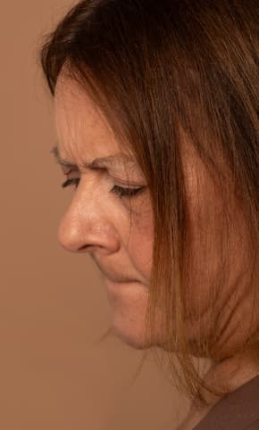 A woman looking down, seeming to worry