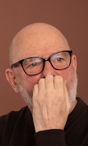 A man looking thoughtfully just off camera