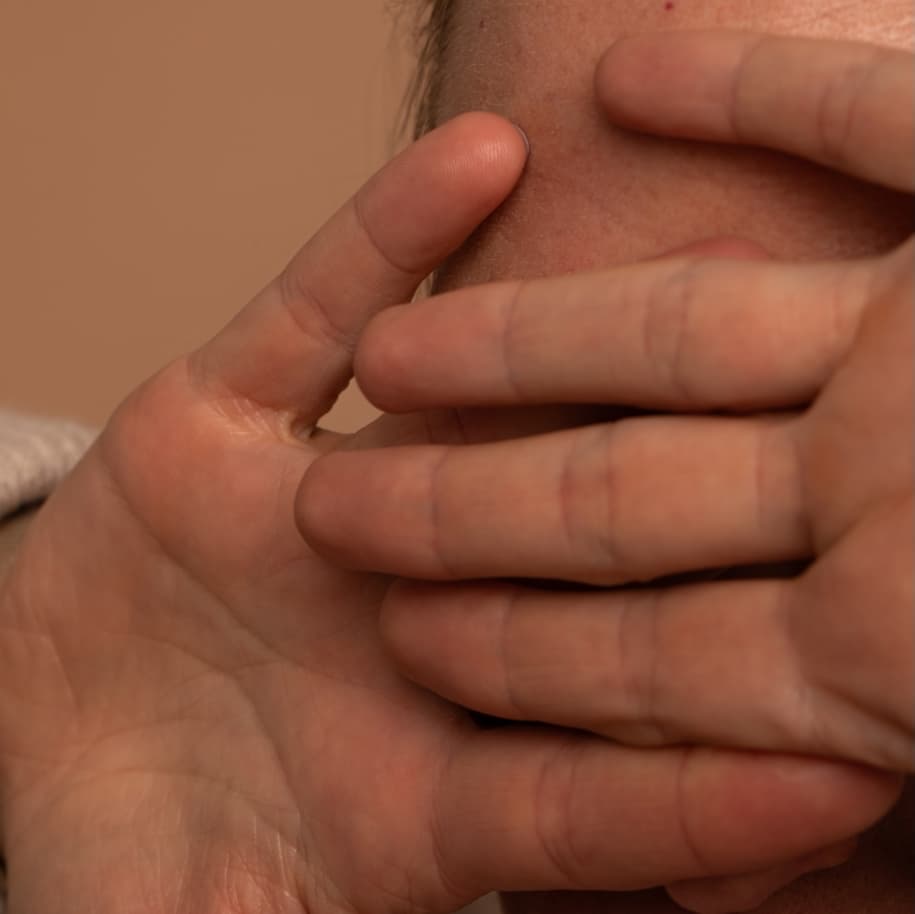 A woman hiding her eyes with her hands