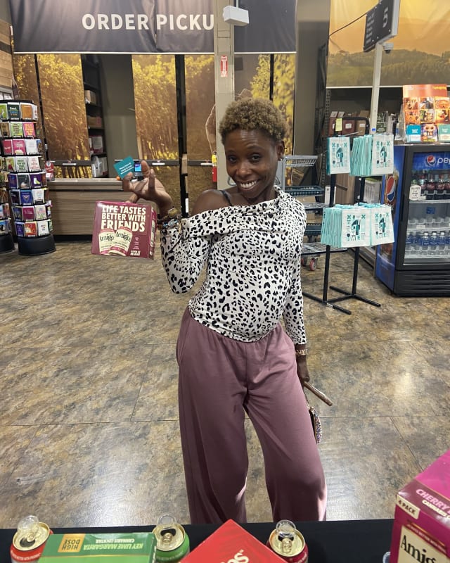 Greenline ambassador engaging shoppers at an Amigos activation