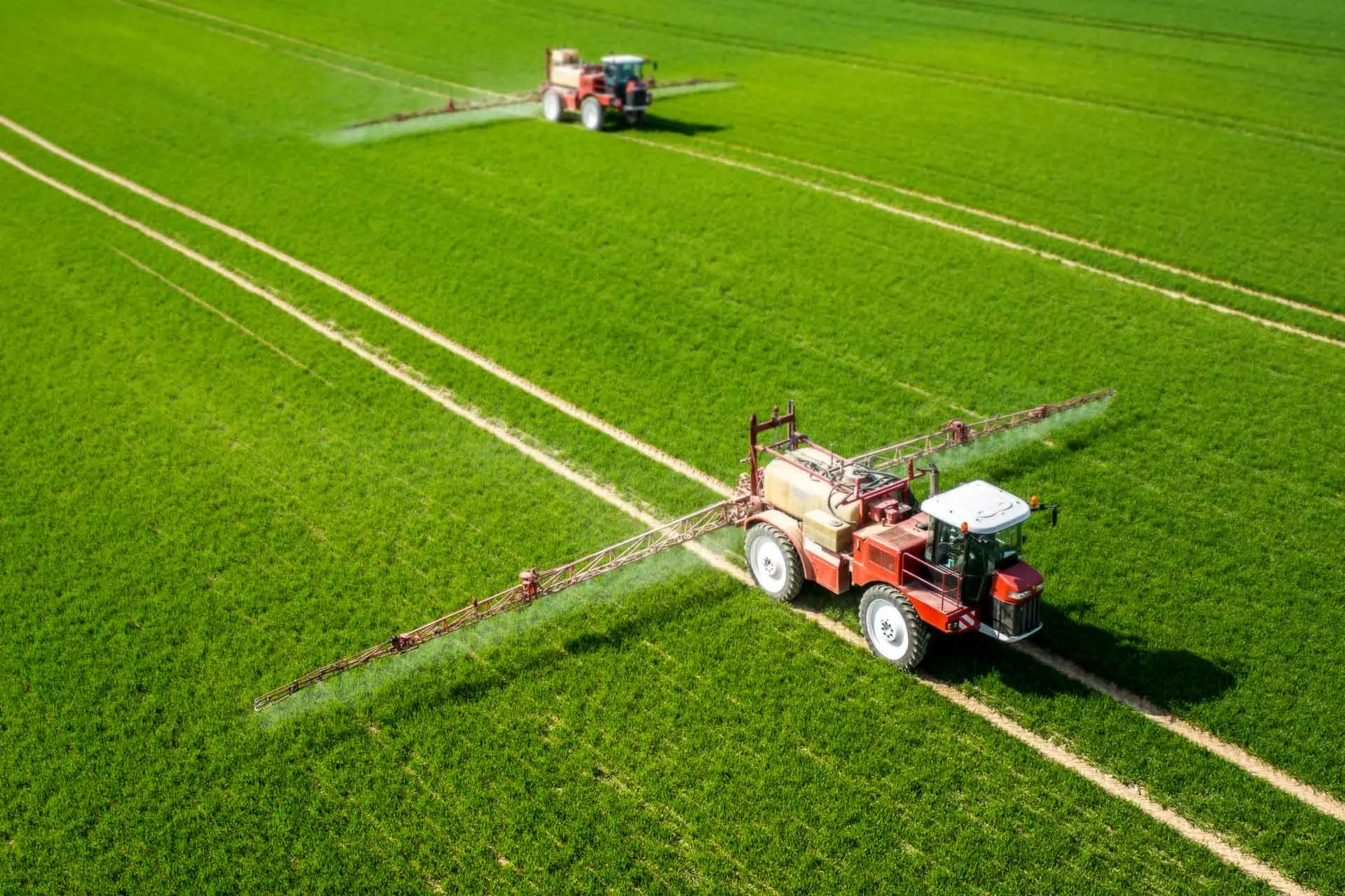 Tractors spraying spring nitrogen fertilizer.
