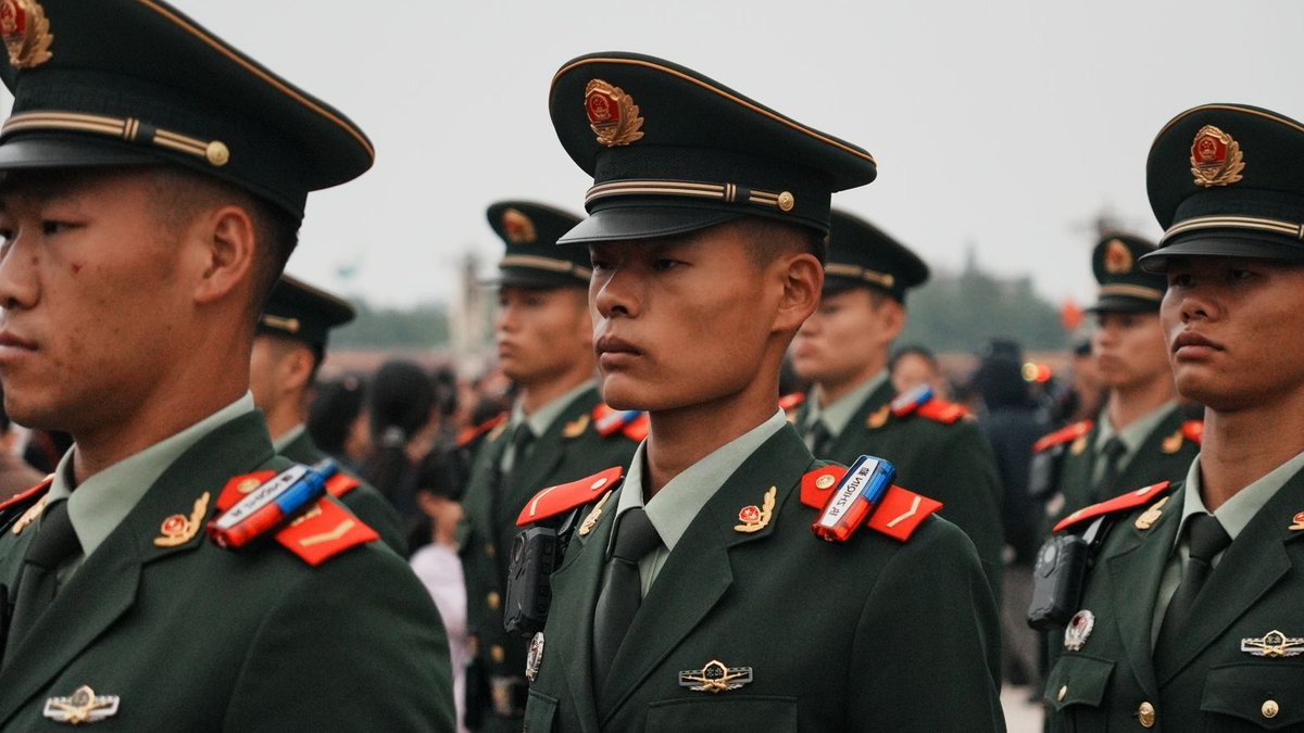 Germany students protest military conscription push Close-up of military personnel in green uniforms and hats during a parade.