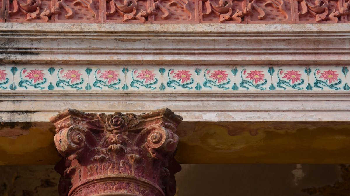 Close-up of an ornate architectural column with intricate floral designs and carvings.