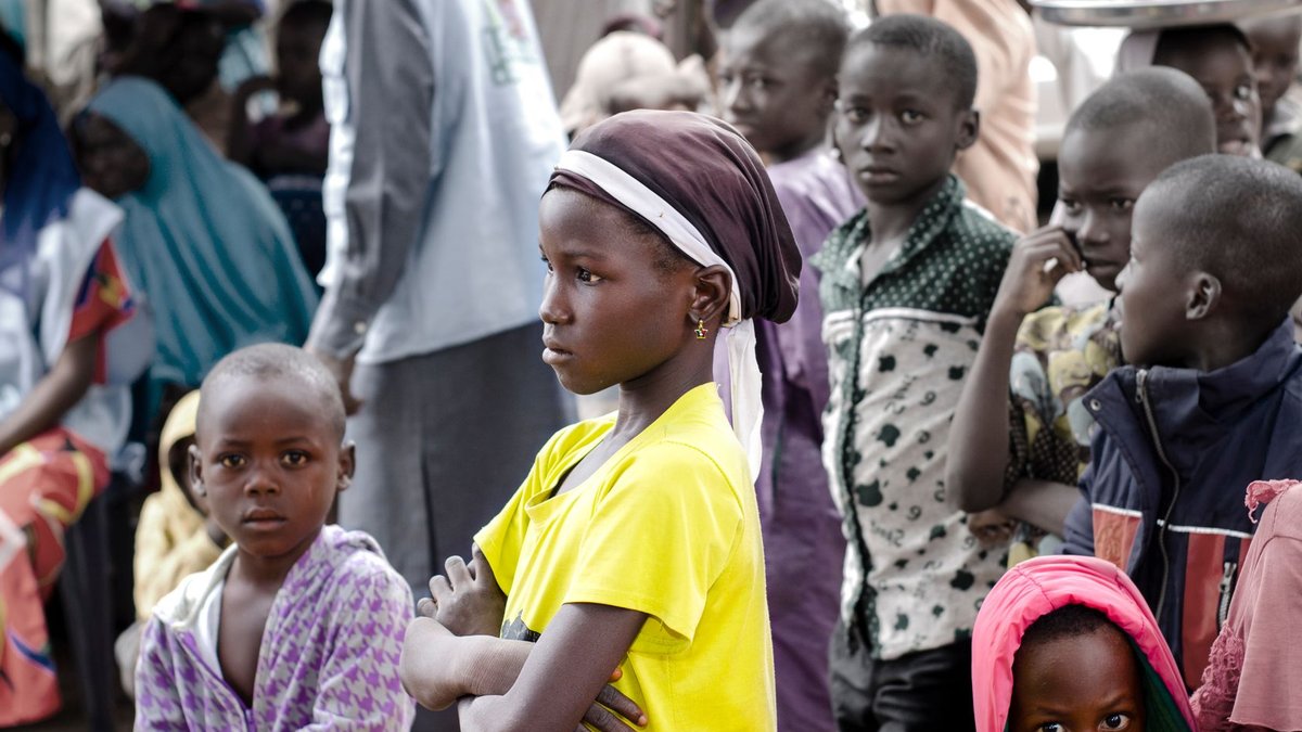 Nigeria tackles sickle cell disease A group of children gathered together outdoors in Abuja, Nigeria, showcasing diversity and community.